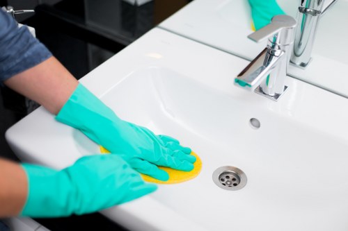 Local cleaner handling weekly cleaning tasks in a Merton apartment
