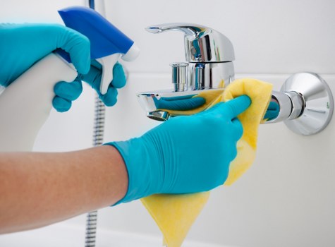 Deep cleaning kitchen surfaces and appliances during a move-out clean in Merton
