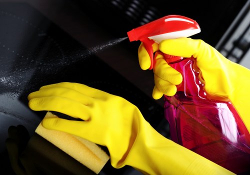 Professional office cleaner maintaining desks and communal spaces in Merton